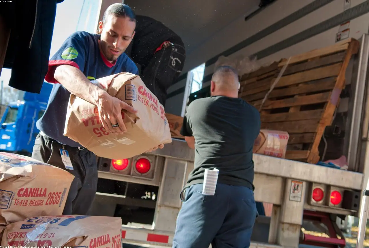 Volunteers handing out boxes of groceries